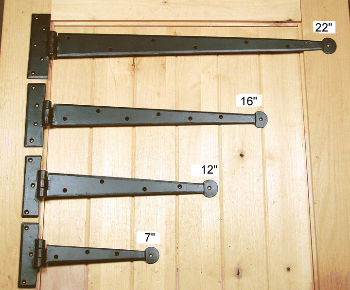 A photo of 4 colonial hinges that measure 7, 12, 16, and 22 inches. Hinges feature a matte black finish.