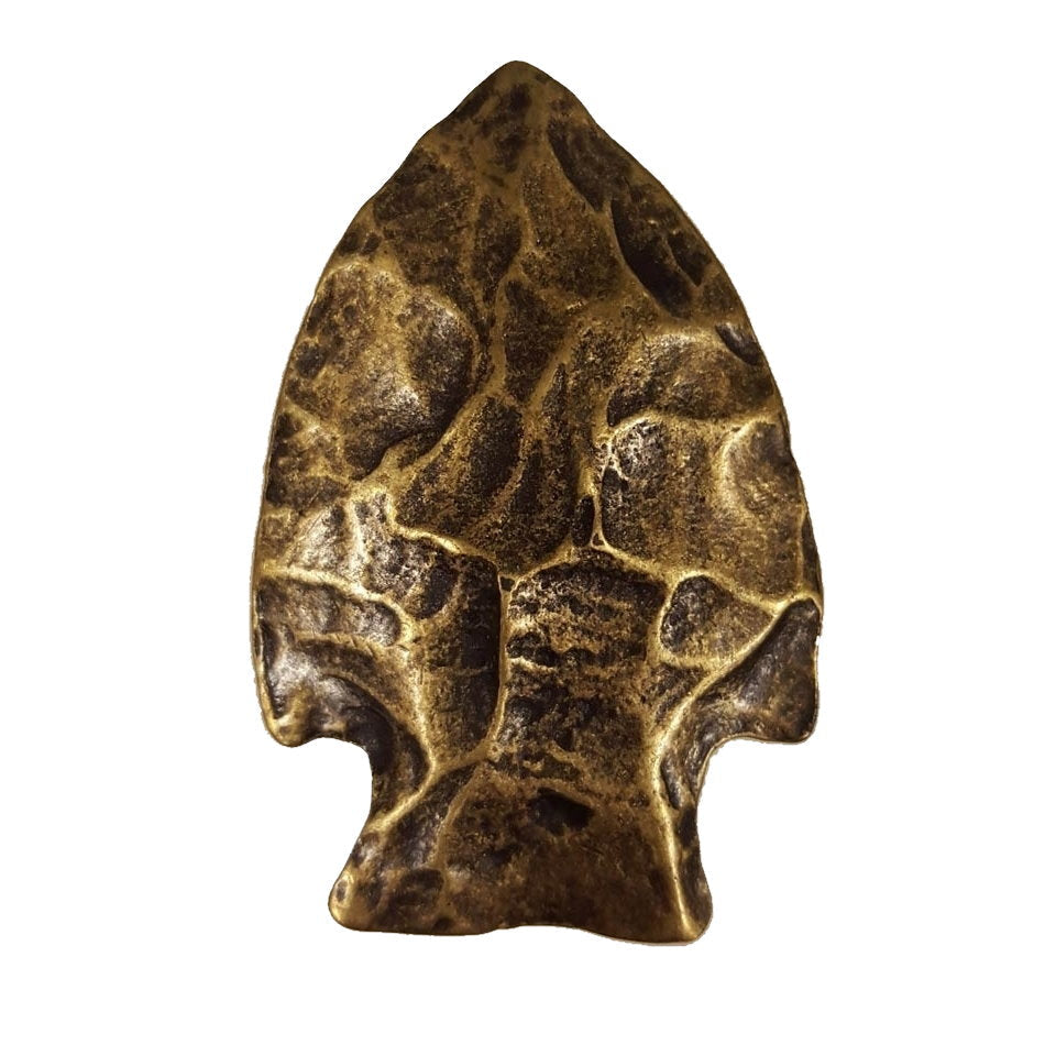 An arrowhead cabinet knob with in an antique brass finish.