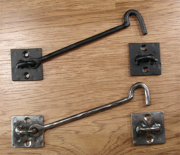 A photo of black and silver forged iron hooks.