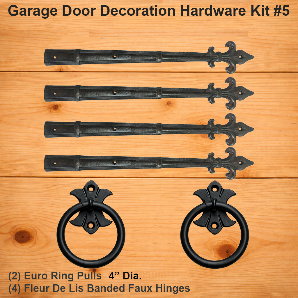 Garage door decoration hardware kit #5 with black metal Euro ring pulls and Fleur De Lis banded faux hinges on a wooden background.