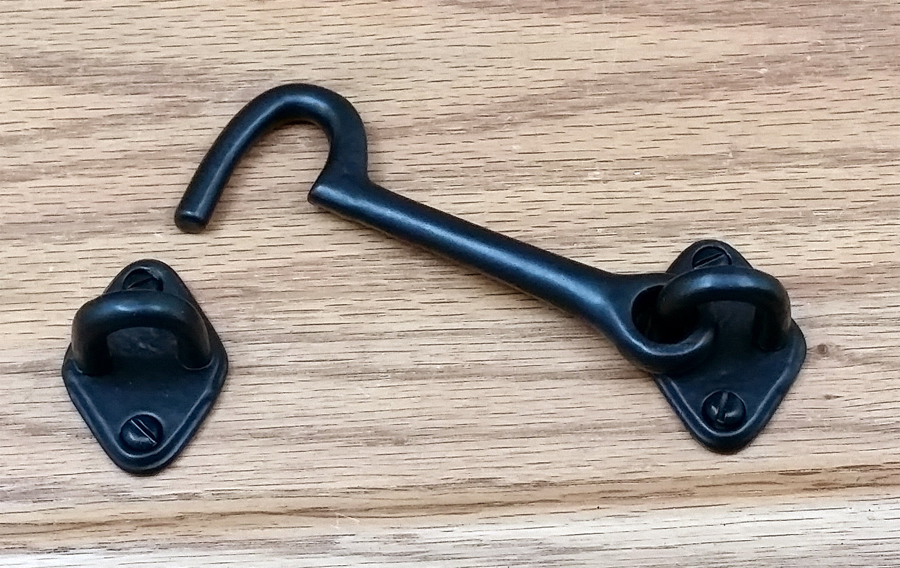 A 4-inch iron hook with an open end, used for hanging things, displayed on a white background.