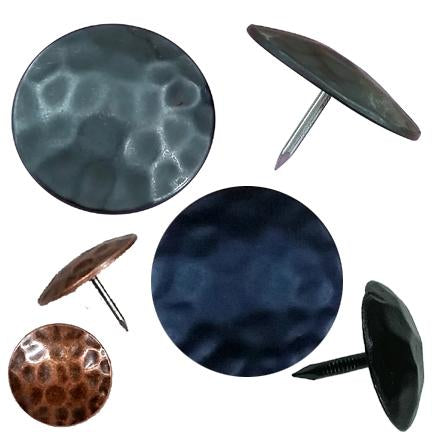 Round clavos, decorative nail heads with a rustic appearance, displayed on a white background.