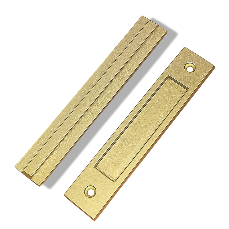 Two gold door handles on a white background