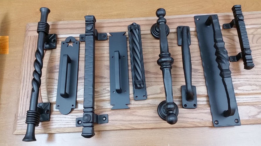 Assorted barn door handles with different designs and finishes, displayed on a white background.