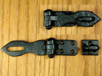 A distressed hasp, a metal fastener with a hinged strap and a slotted post, displayed on a white background.