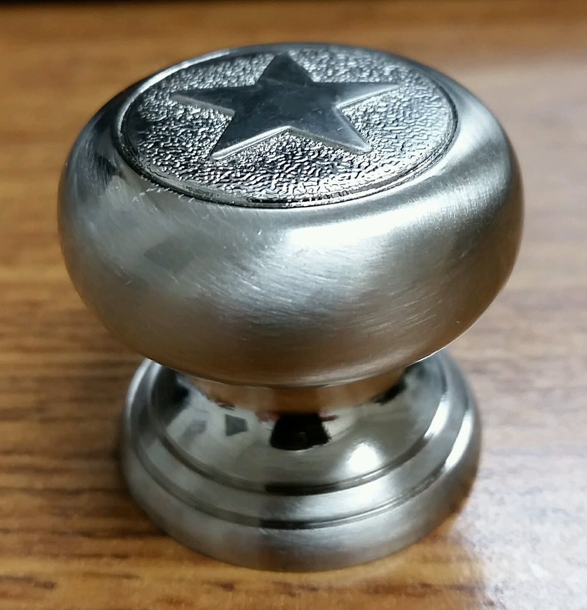 A star-shaped knob viewed from the front, used as a decorative drawer or cabinet pull, displayed on a white background.